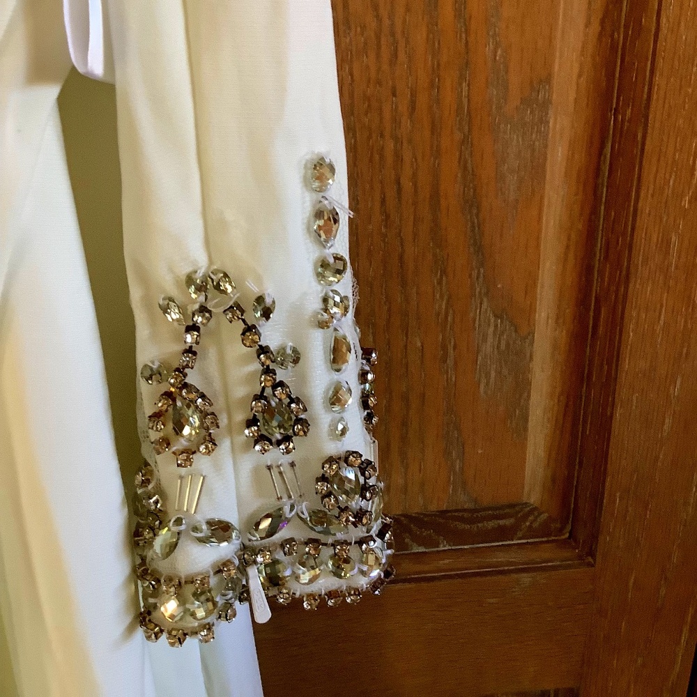 Leena for MacDuggal white dress with embellished sleeves.